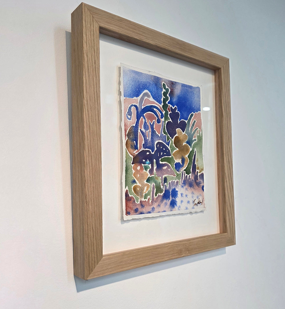 Maleriet "Solgløtt" er rammet inn med eik og kunstglass. 